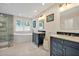Luxurious bathroom with dual vanities, a freestanding tub, and a separate glass-enclosed shower at 206 Zapata Ln, Chapel Hill, NC 27517