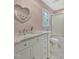 Charming bathroom with a marble vanity, unique heart-shaped mirror, and shower with sliding glass door at 206 Zapata Ln, Chapel Hill, NC 27517