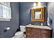 Elegant powder room with a granite countertop, custom vanity, and gold framed mirror at 206 Zapata Ln, Chapel Hill, NC 27517