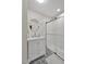 Modern bathroom featuring a sleek vanity, round mirror, and a glass-enclosed shower with patterned tile at 206 Zapata Ln, Chapel Hill, NC 27517