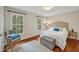 Bright bedroom with hardwood floors, plush bedding, and large windows showcasing the view at 206 Zapata Ln, Chapel Hill, NC 27517