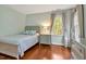 Serene bedroom with light green walls, hardwood floors, and a comfortable twin bed near a window at 206 Zapata Ln, Chapel Hill, NC 27517