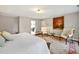 Spacious bedroom with hardwood floors, sitting area, and an ensuite bathroom entrance at 206 Zapata Ln, Chapel Hill, NC 27517