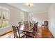 Formal dining room featuring hardwood floors, wainscoting and a large dining table at 206 Zapata Ln, Chapel Hill, NC 27517