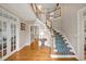 Elegant foyer features hardwood floors, staircase with carpet runner and white wooden banister at 206 Zapata Ln, Chapel Hill, NC 27517