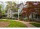 Charming two-story home with manicured lawn, brick walkway, dormer windows and dark shutters at 206 Zapata Ln, Chapel Hill, NC 27517