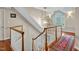 Bright hallway featuring a decorative light fixture and beautiful hardwood floors at 206 Zapata Ln, Chapel Hill, NC 27517