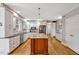 Bright, open kitchen with stainless steel appliances, center island, and ample cabinet space at 206 Zapata Ln, Chapel Hill, NC 27517