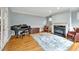 Cozy living room with fireplace, hardwood floors, piano and natural light at 206 Zapata Ln, Chapel Hill, NC 27517
