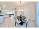 Open-concept dining area leading to a kitchen with a breakfast bar, all with modern finishes at 21 Shoreline Dr, Lillington, NC 27546