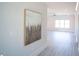 Bright interior hallway leading to a spacious living area with light gray flooring and modern ceiling fixtures at 21 Shoreline Dr, Lillington, NC 27546