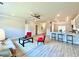 Open-concept living room with modern furniture, light wood floors, and a view of the kitchen at 21 Shoreline Dr, Lillington, NC 27546