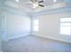 Bright main bedroom with tray ceilings, ceiling fan and plush neutral carpeting at 21 Shoreline Dr, Lillington, NC 27546