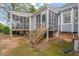 Backyard of home boasts multiple screened-in porches and a wooden staircase at 2102 Trailridge Ct, Raleigh, NC 27603