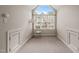 This bright bedroom boasts a large arched window and neutral walls at 2102 Trailridge Ct, Raleigh, NC 27603