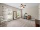 Bright bedroom with neutral carpet, two windows, and decorated with furniture and decor at 2102 Trailridge Ct, Raleigh, NC 27603