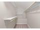 Walk in closet features built in shelving and hanging rods at 2102 Trailridge Ct, Raleigh, NC 27603