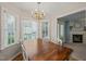 Bright dining room with a wooden table, chandelier, bay window with shutters, and hardwood floors at 2102 Trailridge Ct, Raleigh, NC 27603