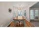 Cozy dining room with a wooden table, chandelier, bay window with shutters, and hardwood floors at 2102 Trailridge Ct, Raleigh, NC 27603