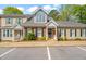 Charming townhome featuring a brick facade, a gray roof, a well-maintained lawn and black shutters at 2102 Trailridge Ct, Raleigh, NC 27603