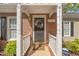 Close up of the front door with a wreath and white columns with the house number '2102' at 2102 Trailridge Ct, Raleigh, NC 27603