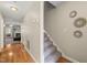 Hallway with hardwood floors, a staircase, leading into a living room with a fireplace at 2102 Trailridge Ct, Raleigh, NC 27603
