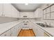 The kitchen features bright white cabinets, stainless steel appliances, countertops, and hardwood floors at 2102 Trailridge Ct, Raleigh, NC 27603