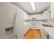 Bright kitchen featuring white appliances, cabinets, and countertops plus hardwood floors at 2102 Trailridge Ct, Raleigh, NC 27603