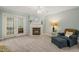 Comfortable living room featuring a fireplace, French doors, and soft blue walls at 2102 Trailridge Ct, Raleigh, NC 27603