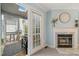Inviting living room featuring a fireplace, neutral decor, and access to a porch through glass doors at 2102 Trailridge Ct, Raleigh, NC 27603
