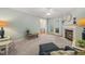 Inviting living room featuring a fireplace, neutral decor, and access to a porch through glass doors at 2102 Trailridge Ct, Raleigh, NC 27603