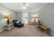 Comfortable living room showcasing a fireplace, blue walls, neutral carpeting, and stylish lamps at 2102 Trailridge Ct, Raleigh, NC 27603