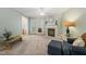 Inviting living room featuring a fireplace, French doors, and neutral carpeting at 2102 Trailridge Ct, Raleigh, NC 27603