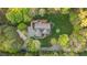 A well-manicured lawn surrounds this home, nestled between mature hardwood trees at 2204 Secluded Oaks Ct, Wake Forest, NC 27587