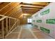 Unfinished attic with visible wood framing, plywood subfloor, EasyGuard housewrap and natural light from a window at 2204 Secluded Oaks Ct, Wake Forest, NC 27587