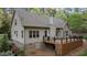 Back exterior featuring spacious deck, fenced yard, walk-out basement, and lush lawn at 2204 Secluded Oaks Ct, Wake Forest, NC 27587