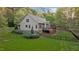 Back exterior featuring spacious deck, fenced yard, and lush lawn at 2204 Secluded Oaks Ct, Wake Forest, NC 27587