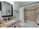 Bathroom with granite countertop, shower and tub, and neutral tile at 2204 Secluded Oaks Ct, Wake Forest, NC 27587