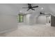 Spacious bedroom features neutral walls, carpet, two ceiling fans, and a window view to a wooded area at 2204 Secluded Oaks Ct, Wake Forest, NC 27587