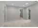 Spacious bonus room with multiple doors, natural light, and neutral carpet at 2204 Secluded Oaks Ct, Wake Forest, NC 27587