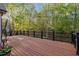 Large wooden deck surrounded by lush trees, perfect for outdoor entertaining at 2204 Secluded Oaks Ct, Wake Forest, NC 27587