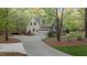 Long driveway leads to a spacious two-car garage and a well-maintained, landscaped yard at 2204 Secluded Oaks Ct, Wake Forest, NC 27587