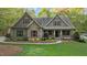 Charming home featuring stone accents, landscaped yard, covered porch and meticulous landscaping at 2204 Secluded Oaks Ct, Wake Forest, NC 27587