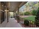 Covered front porch with stone pillars, iron railing, and recessed lights at 2204 Secluded Oaks Ct, Wake Forest, NC 27587