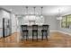 Modern kitchen with stainless steel appliances and a breakfast bar with seating at 2204 Secluded Oaks Ct, Wake Forest, NC 27587