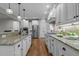 Gourmet kitchen with granite countertops, stainless steel appliances, white cabinets, and wood floors at 2204 Secluded Oaks Ct, Wake Forest, NC 27587