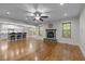 Spacious living room with a stone fireplace, hardwood floors, and a view of the kitchen at 2204 Secluded Oaks Ct, Wake Forest, NC 27587