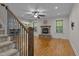 Inviting living room with hardwood floors, stone fireplace, and large windows for natural light at 2204 Secluded Oaks Ct, Wake Forest, NC 27587