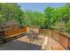 Wooden deck with built-in bench seating and a beautiful view of lush greenery at 2416 W Club Blvd, Durham, NC 27705