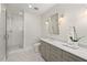 Bathroom with a tiled walk-in shower, gray vanity, and hexagon tile flooring at 2416 W Club Blvd, Durham, NC 27705